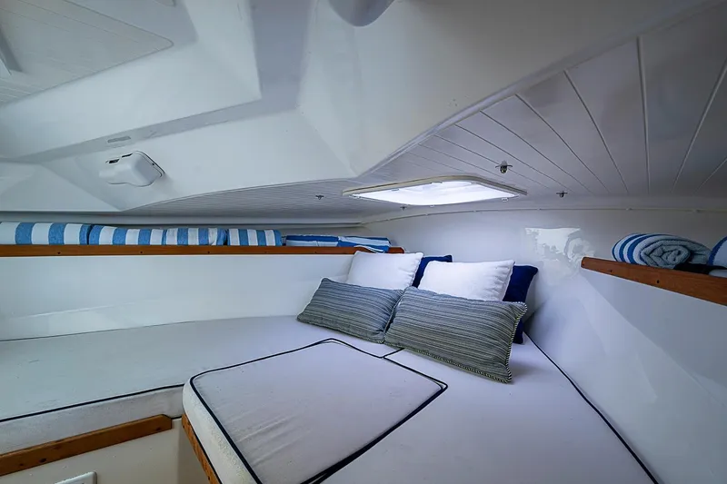 Slide: The Image of Cozy cabin interior of 2020 Hunt Yachts Harrier 26 with cushions and striped towels. - 25