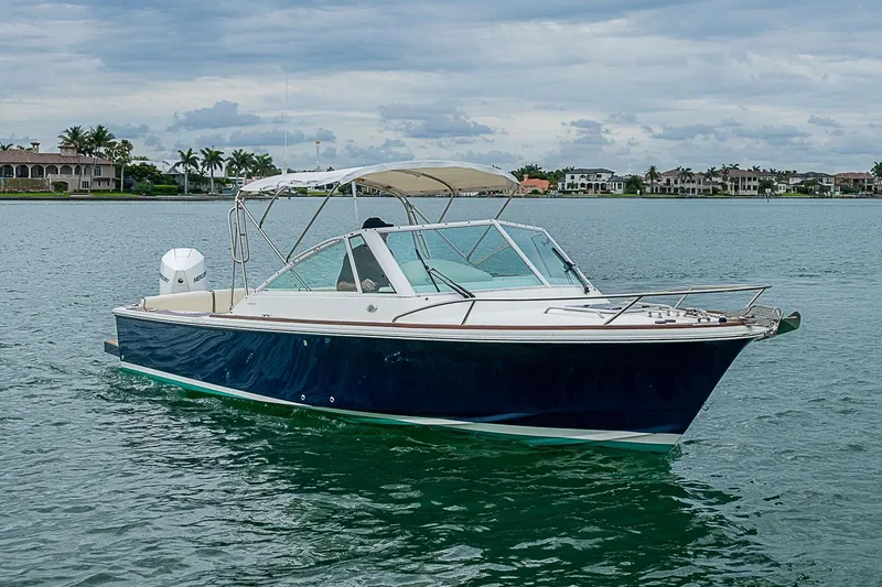 Slide: The Image of 2020 Hunt Yachts Harrier 26 cruising on calm waters under a cloudy sky. - 3