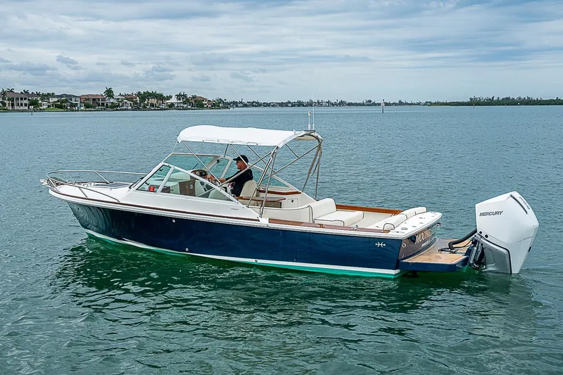 Slide: The Image of 2020 Hunt Yachts Harrier 26 cruising on calm waters with a Mercury outboard engine. - 7