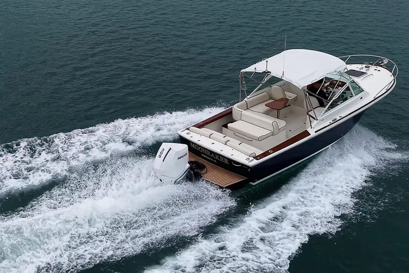 Slide: The Image of 2020 Hunt Yachts Harrier 26 cruising on open water, showcasing sleek design and powerful engine. - 8