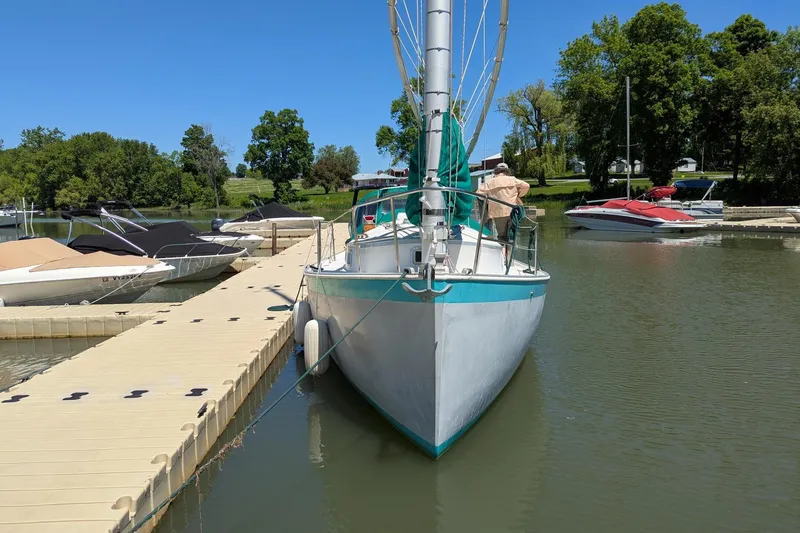 Slide: The Image of 1985 Nonsuch 26 Classic sailboat docked at a marina on a sunny day. - 10