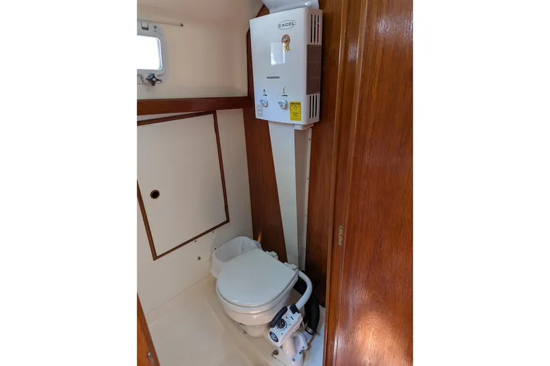 Slide: The Image of 1985 Nonsuch 26 Classic yacht bathroom with toilet and water heater. - 4