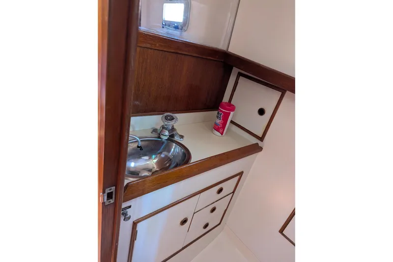 Slide: The Image of 1985 Nonsuch 26 Classic yacht interior with sink and storage cabinets. - 5