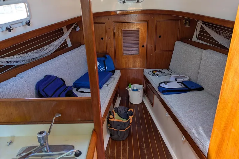 Slide: The Image of Interior of a 1985 Nonsuch 26 Classic sailboat with wooden finishes and seating area. - 6