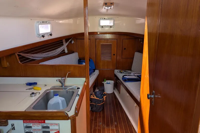 Slide: The Image of Interior of 1985 Nonsuch 26 Classic sailboat with wooden finishes and compact kitchen. - 9
