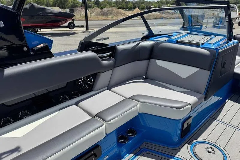 Slide: The Image of 2022 Moomba Kaiyen boat interior with blue and gray seating, showcasing modern design. - 10