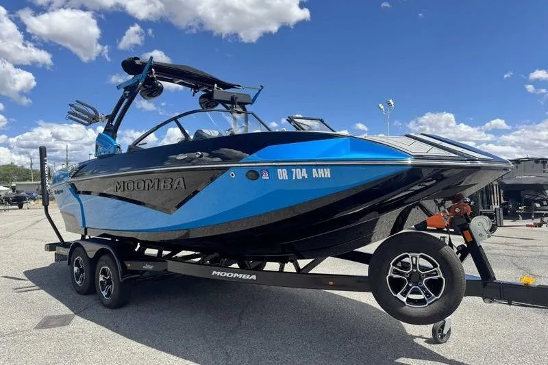 Slide: The Image of 2022 Moomba Kaiyen boat on trailer under blue sky. - 11
