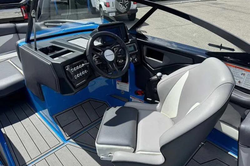 Slide: The Image of 2022 Moomba Kaiyen boat interior with steering wheel and captain's seat. - 14