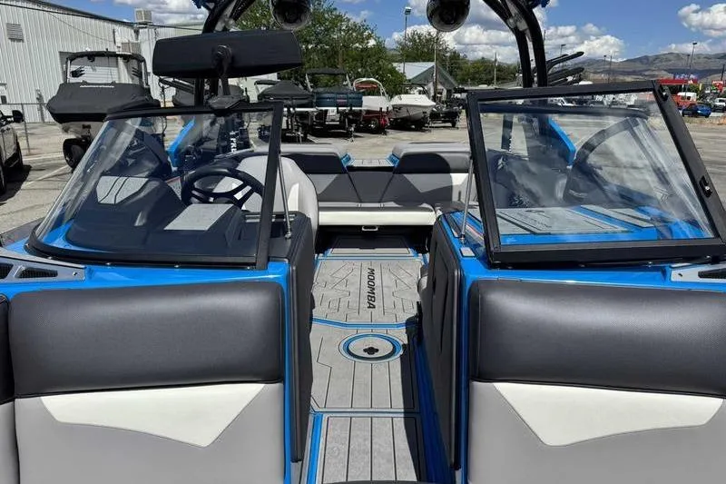 Slide: The Image of 2022 Moomba Kaiyen boat interior with blue accents and seating. - 15