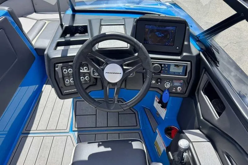Slide: The Image of 2022 Moomba Kaiyen boat dashboard with steering wheel and control panel. - 16