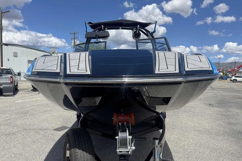Slide: The Image of 2022 Moomba Kaiyen boat on trailer under blue sky with clouds. - 9