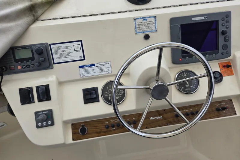 Slide: The Image of Helm of 2008 Mainship 400 Trawler with steering wheel and navigation instruments. - 13