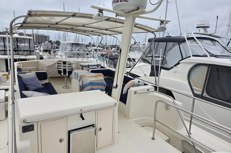 Slide: The Image of 2008 Mainship 400 Trawler yacht interior with seating, docked at marina. - 14
