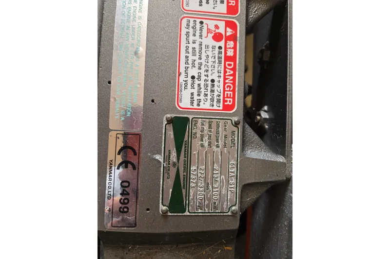 Slide: The Image of Engine warning labels and specifications on a 2008 Mainship 400 Trawler. - 15