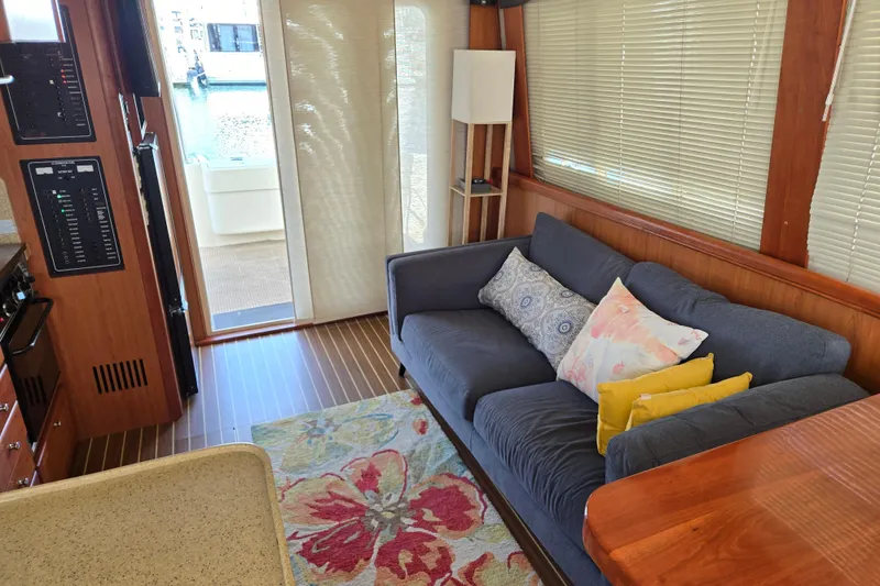Slide: The Image of Interior of 2008 Mainship 400 Trawler with cozy sofa, colorful cushions, and nautical decor. - 21