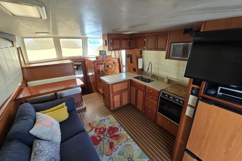 Slide: The Image of Interior of 2008 Mainship 400 Trawler with kitchen, seating, and helm station. - 24