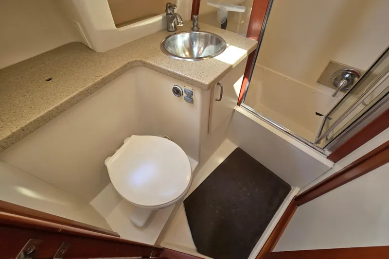 Slide: The Image of 2008 Mainship 400 Trawler bathroom with sink, toilet, and shower area. - 29