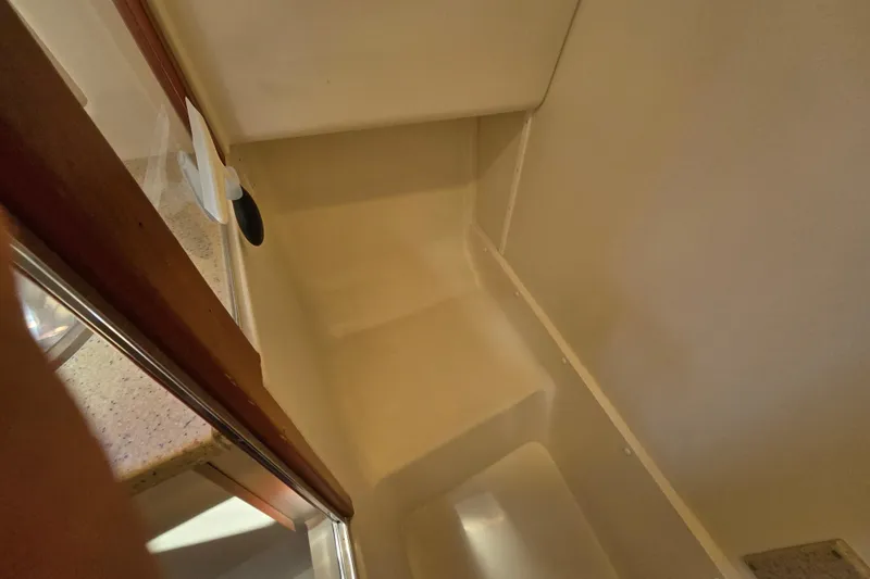 Slide: The Image of Interior view of 2008 Mainship 400 Trawler shower area with beige walls and fixtures. - 31