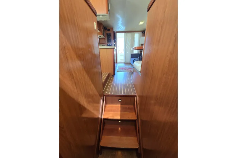 Slide: The Image of Interior view of 2008 Mainship 400 Trawler with wooden stairs and flooring. - 33