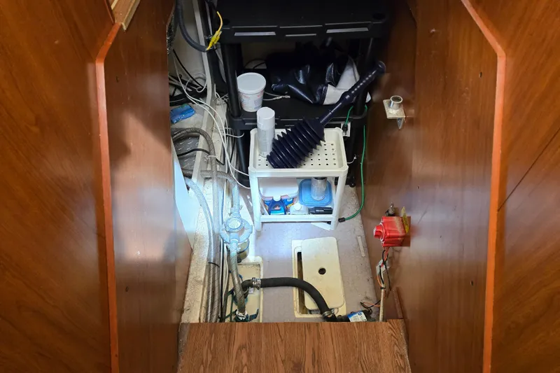 Slide: The Image of Engine room of 2008 Mainship 400 Trawler with equipment and storage shelves. - 34