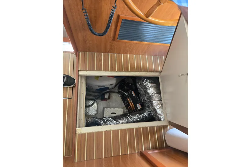 Slide: The Image of Engine compartment of a 2008 Mainship 400 Trawler, showcasing mechanical components. - 36