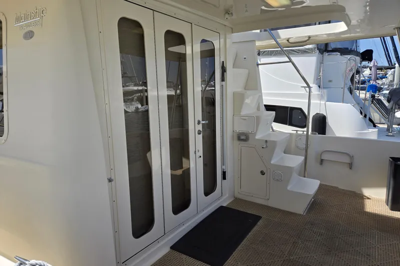 Slide: The Image of 2008 Mainship 400 Trawler yacht deck with stairs and glass doors. - 6