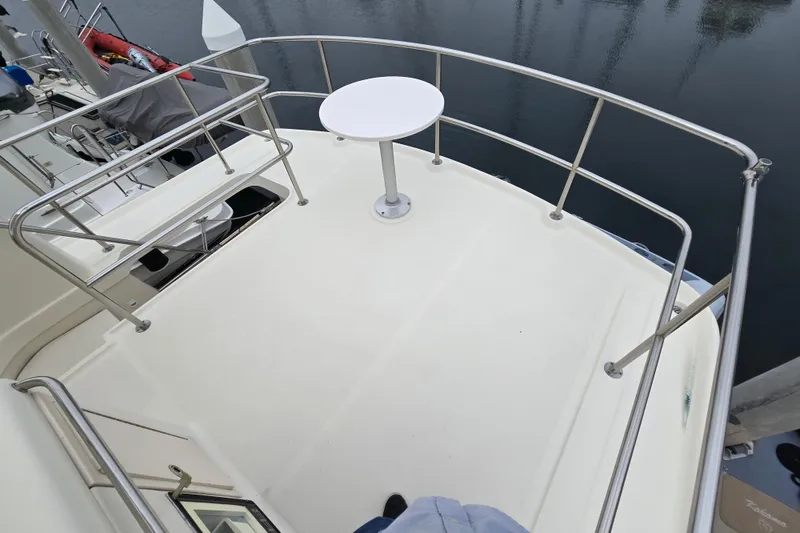 Slide: The Image of 2008 Mainship 400 Trawler deck with railing and small round table. - 8