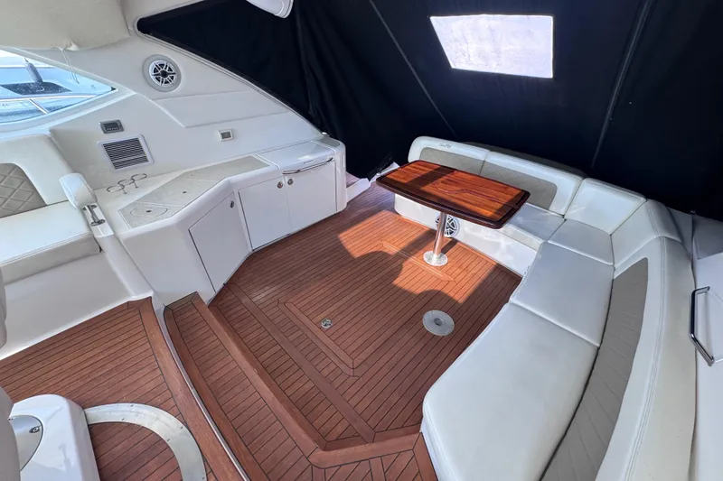 Slide: The Image of Luxurious interior of 2011 Sea Ray 540 Sundancer yacht with elegant seating and wooden table. - 16