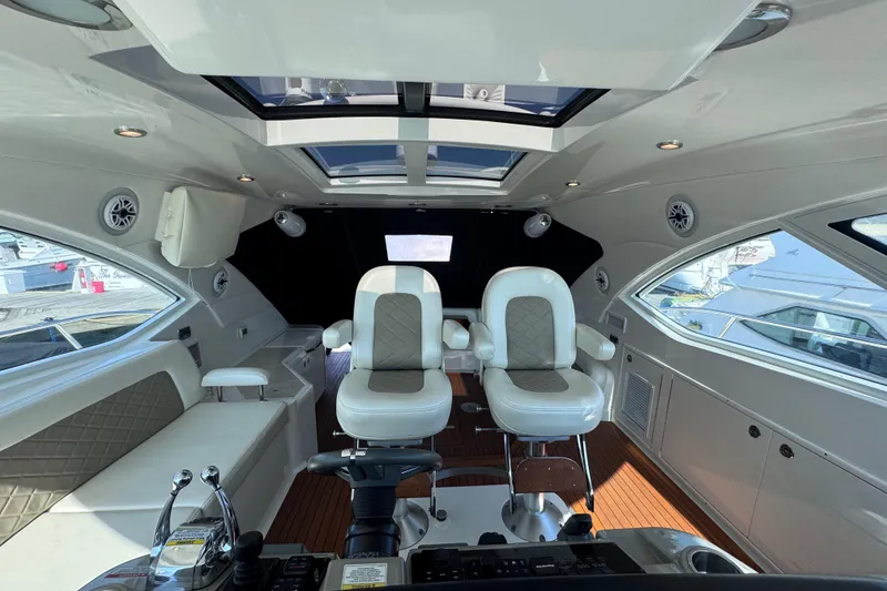 Slide: The Image of Luxurious interior of 2011 Sea Ray 540 Sundancer yacht with plush seating and modern controls. - 35