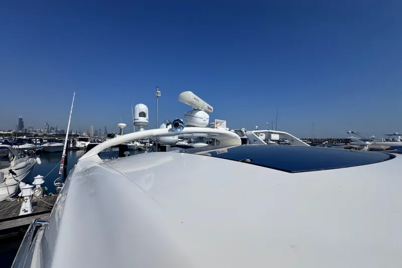 Slide: The Image of 2011 Sea Ray 540 Sundancer yacht docked in marina under clear blue sky. - 4
