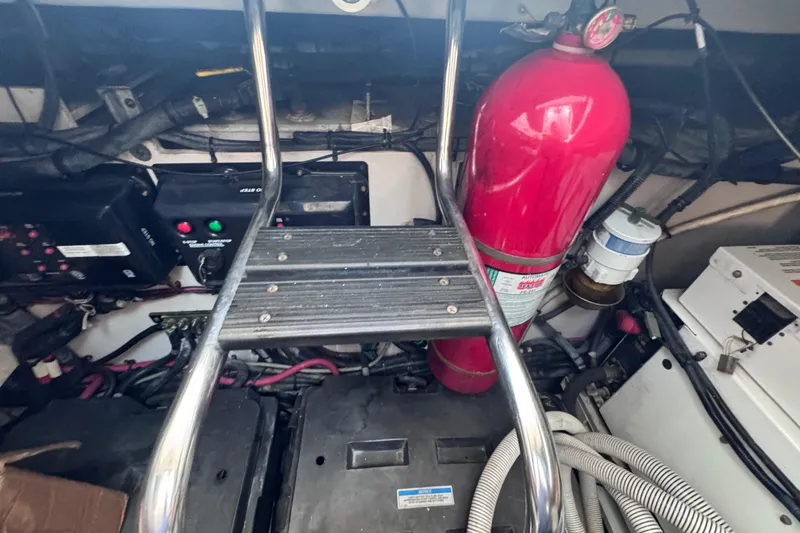 Slide: The Image of Engine room of 2011 Sea Ray 540 Sundancer with fire extinguisher and electrical components. - 74
