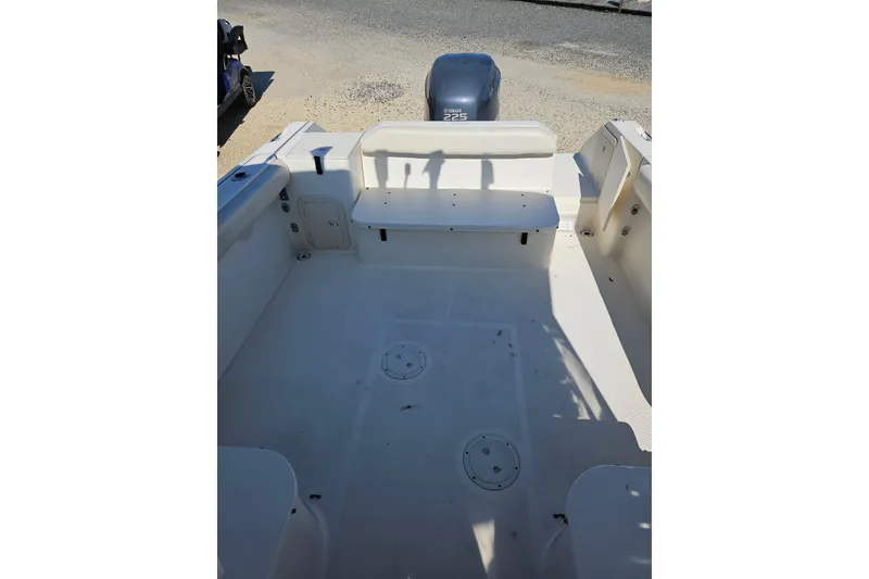 Slide: The Image of 2004 Pursuit 2470 Walkaround boat interior with Yamaha 225 engine. - 4