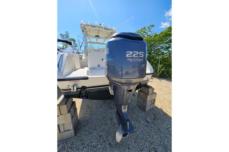 Slide: The Image of 2004 Pursuit 2470 Walkaround boat with Yamaha 225 outboard motor on blocks. - 7