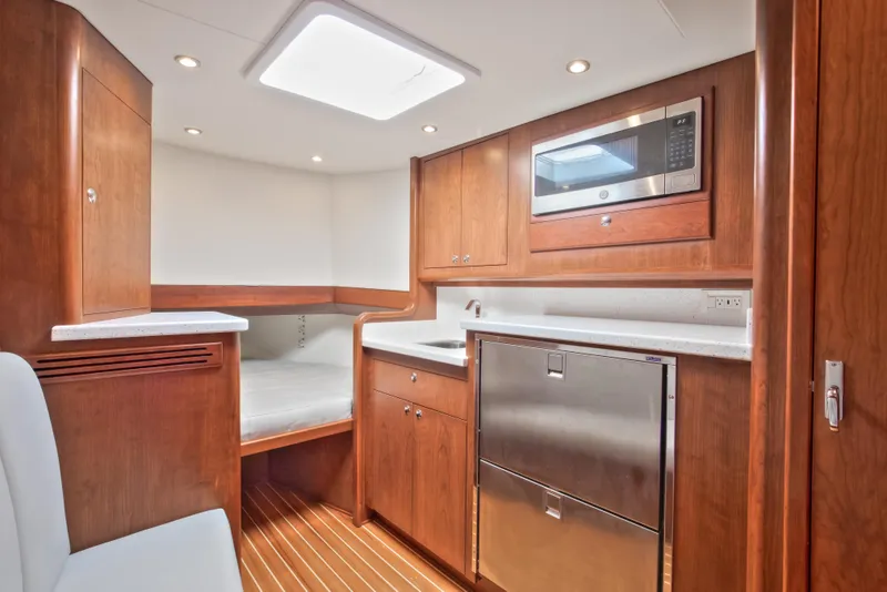 Slide: The Image of Luxurious interior of 2026 Release Boatworks 46 Walkaround with modern kitchen amenities. - 15