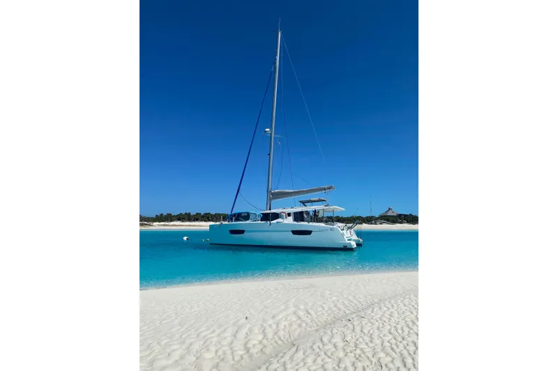 Slide: The Image of 2018 Fountaine Pajot Lucia 40 catamaran anchored in clear turquoise waters. - 3