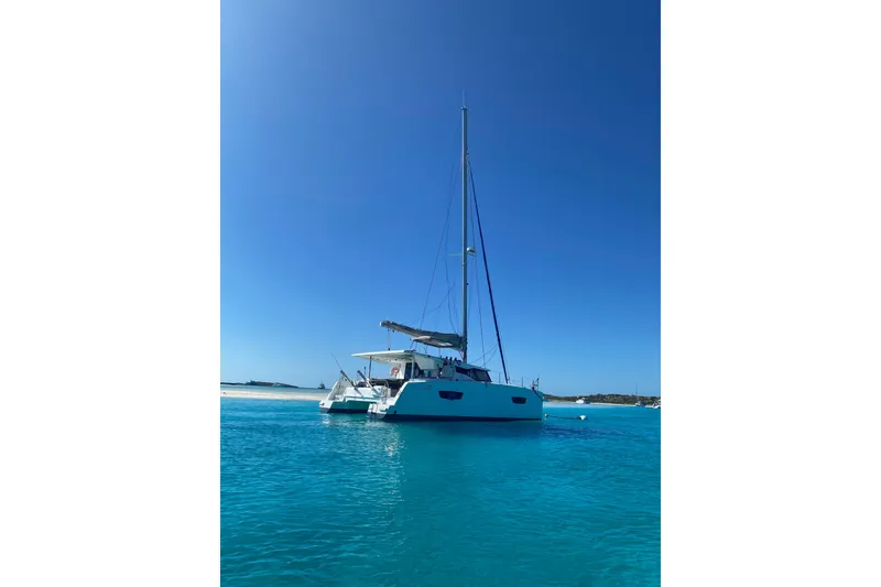 Slide: The Image of 2018 Fountaine Pajot Lucia 40 catamaran sailing on clear blue waters. - 4