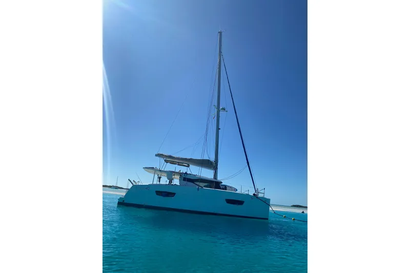 Slide: The Image of 2018 Fountaine Pajot Lucia 40 catamaran sailing on clear blue waters. - 5