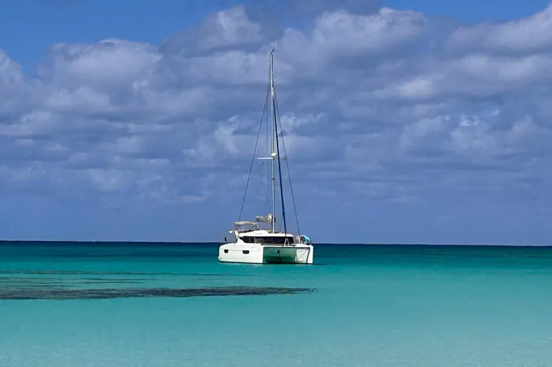 Slide: The Image of 2018 Fountaine Pajot Lucia 40 catamaran sailing on turquoise ocean under cloudy sky. - 7
