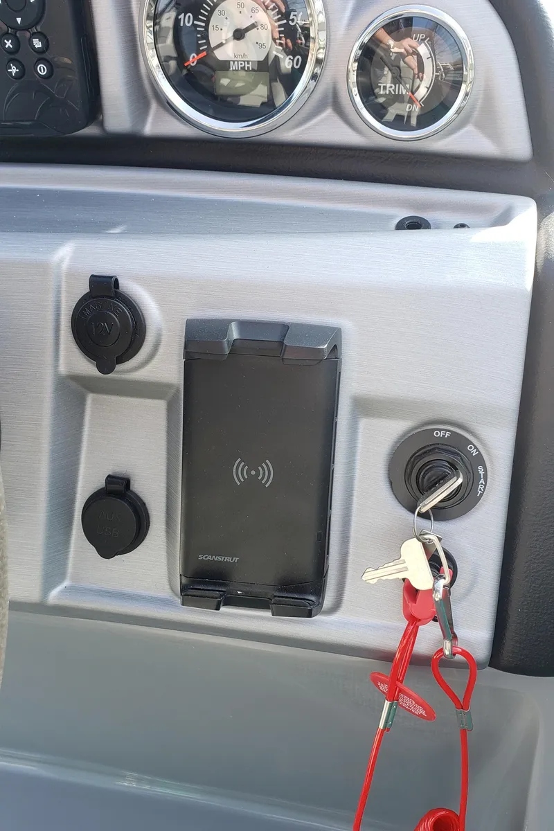 Slide: The Image of Dashboard of 2023 South Bay S224RS25 boat with keys and charger. - 10