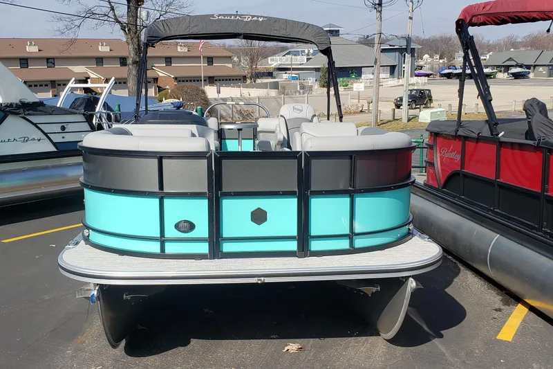 Slide: The Image of 2023 South Bay S224RS25 pontoon boat in parking lot. - 2