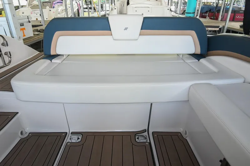 Slide: The Image of Interior seating of 2014 Four Winns H290 boat, featuring white and blue upholstery. - 10