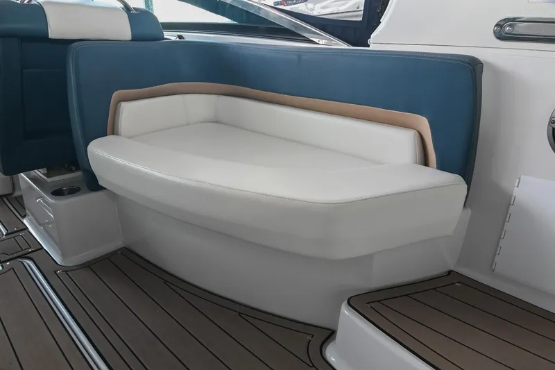 Slide: The Image of 2014 Four Winns H290 boat interior with cushioned seating and wood-style flooring. - 11