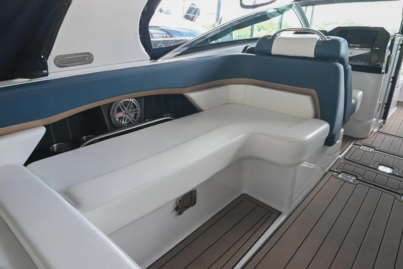 Slide: The Image of Interior of 2014 Four Winns H290 boat with white and blue seating, wooden flooring. - 12