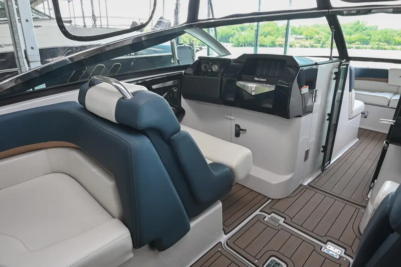 Slide: The Image of Interior of 2014 Four Winns H290 boat with sleek seating and modern dashboard design. - 14