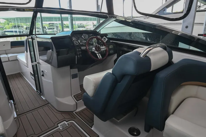 Slide: The Image of 2014 Four Winns H290 boat interior with sleek dashboard and comfortable seating. - 15