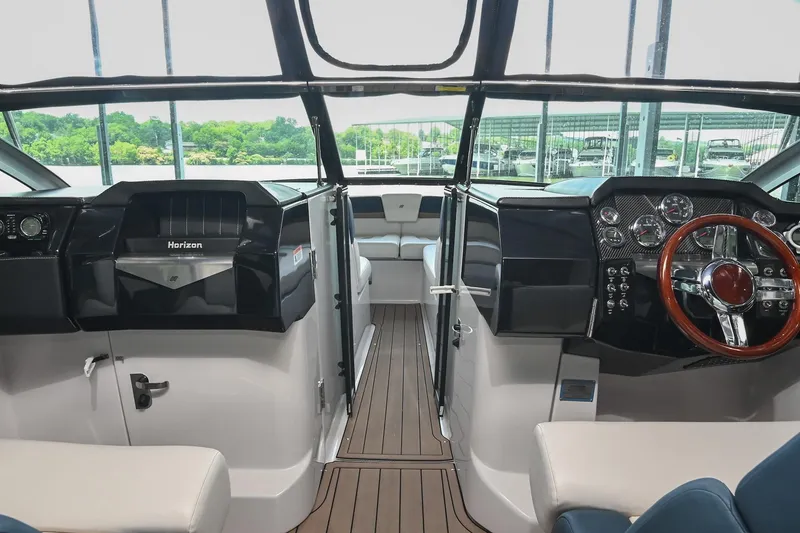 Slide: The Image of Interior of 2014 Four Winns H290 boat with sleek dashboard and modern controls. - 22