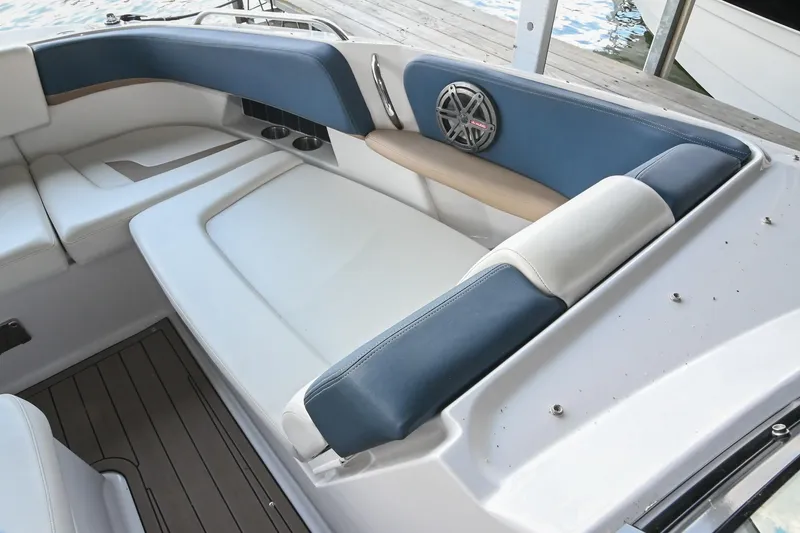 Slide: The Image of Interior seating of a 2014 Four Winns H290 boat with blue and white upholstery. - 28