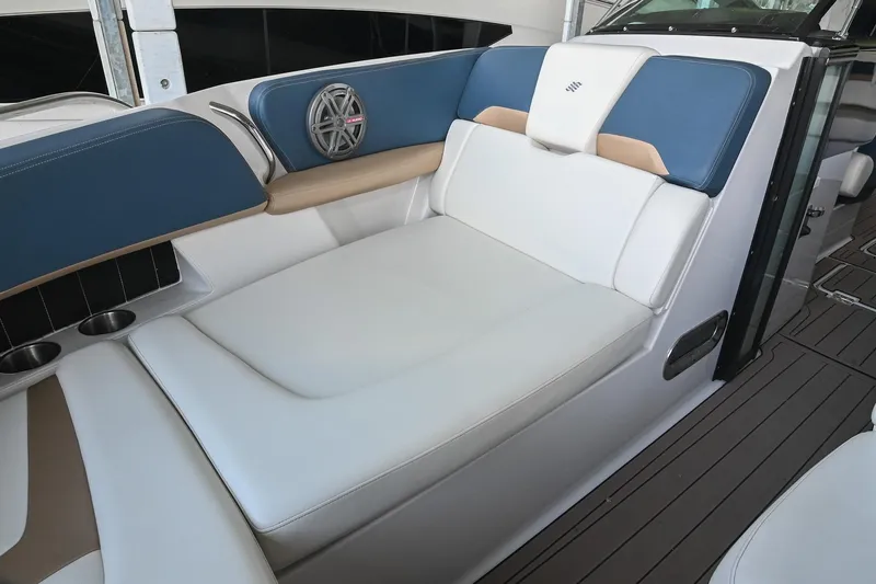 Slide: The Image of Luxurious seating area on a 2014 Four Winns H290 boat, featuring blue and white upholstery. - 30