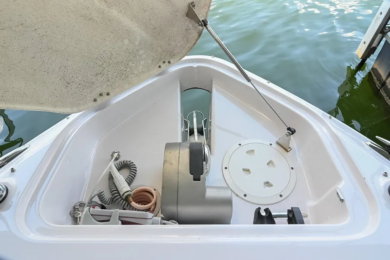 Slide: The Image of Open anchor compartment on 2014 Four Winns H290 boat, showing storage and equipment. - 32