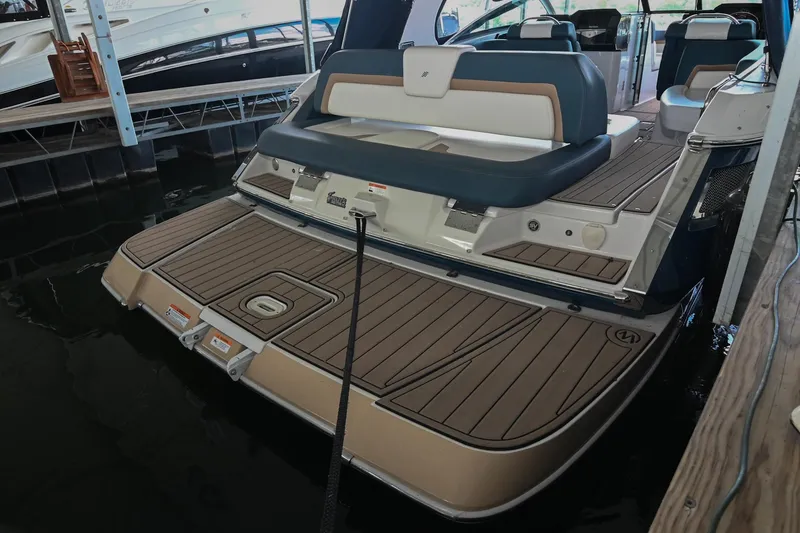 Slide: The Image of 2014 Four Winns H290 boat with spacious deck and seating in a marina. - 4
